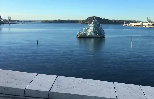 Oslo Layover - "She Lies" made from glass and stainless steel, depicts an iceberg floating in the Harbor.
 