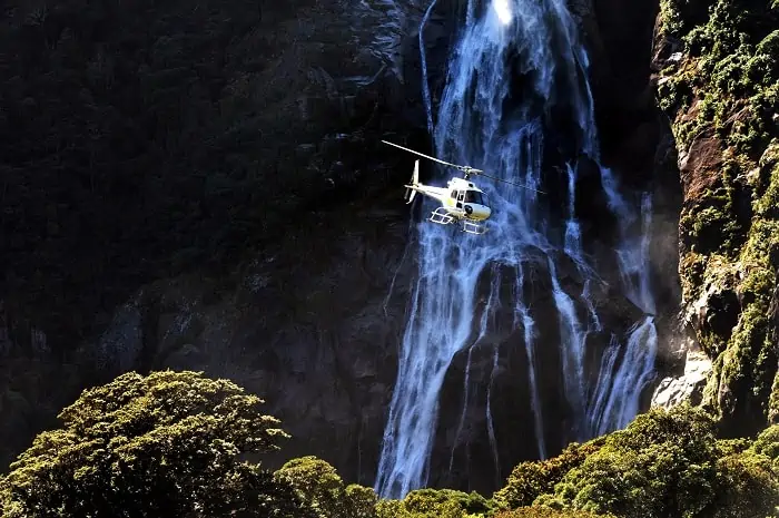 A helicopter flies over Fiordland, southern New Zealand.
