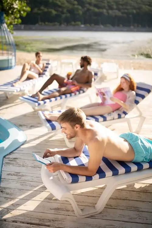 A Picture Showing Vacationers Relaxing by the pool. Tips To Stay Healthy When Traveling