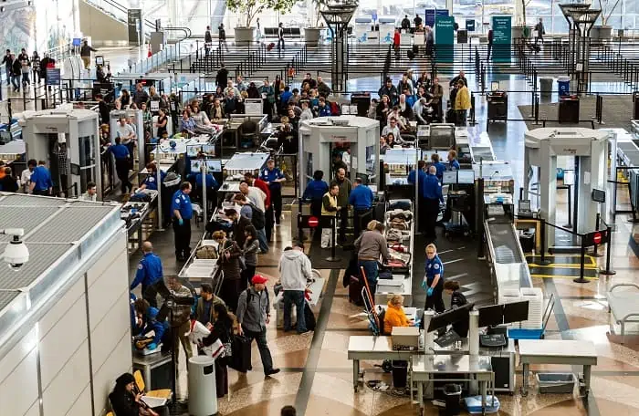 People waiting in line at TSA checkpoint security at airport