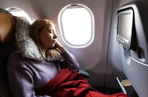 Woman Sleeping on a Plane - How To Sleep On A Plane
