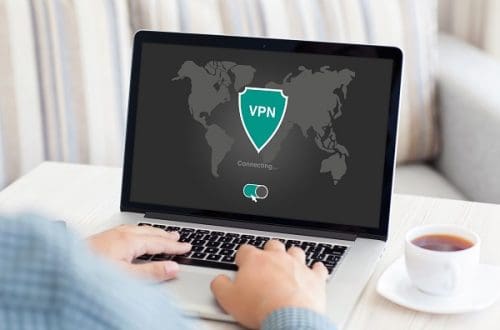 A person holding notebook with their VPN open - Reasons You Should Use a VPN