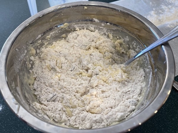 A bowl with the Irish soda bread ingredients getting mixed