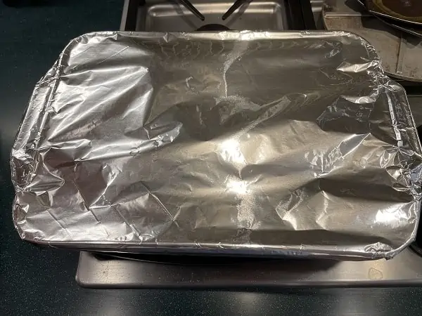 Roasting Pan with Corned Beef Covered with Aluminum Foil Ready For The Oven