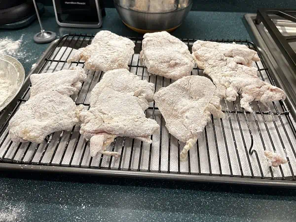 Chicken Pieces on Wire Rack Ready to Deep Fry