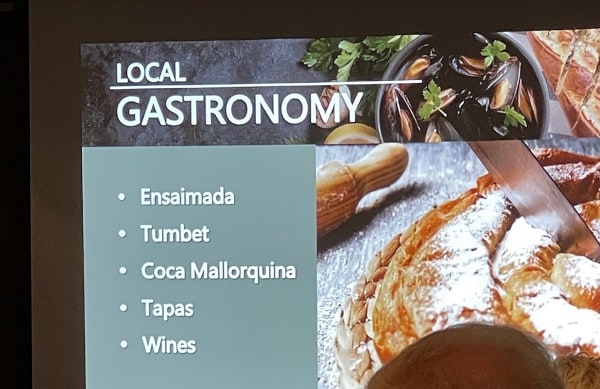 Slide listing typical foods in Palma de Mallorca with a photo of an Ensaimada
