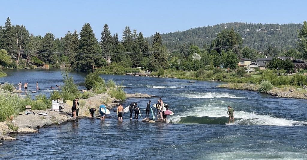 People Surfing and Learning to Surf on the Deschutes River In Bend Oregon
