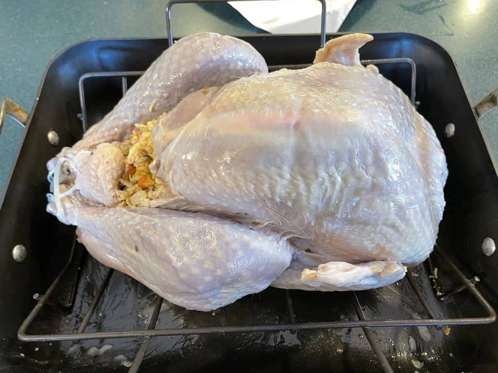 Stuffed Brined Turkey Sitting On Roasting Rack