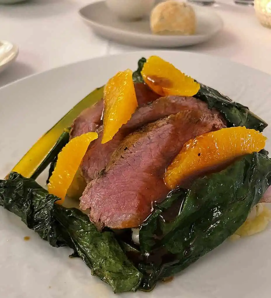 My entree - Local pork with greens and oranges