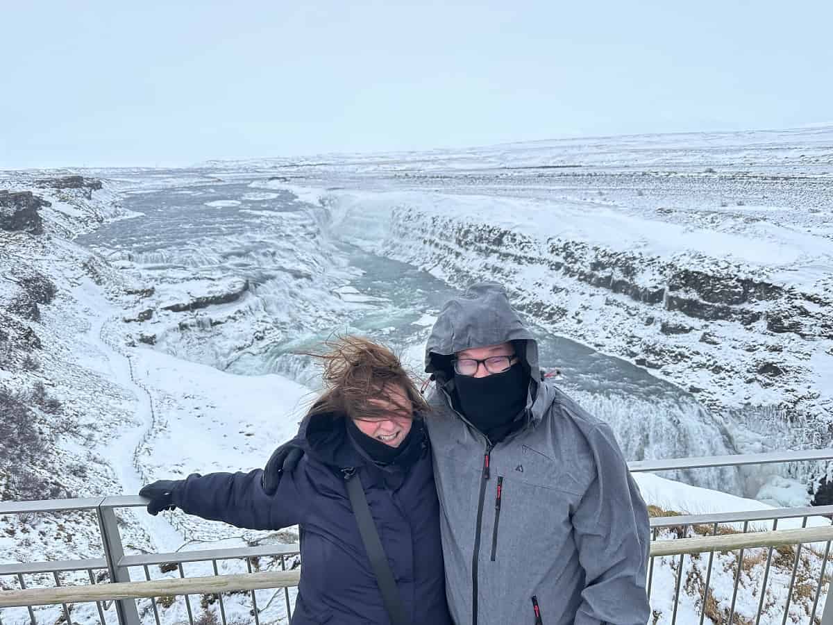 The Author and her Husband in front of Gullfoss in heavy winds.