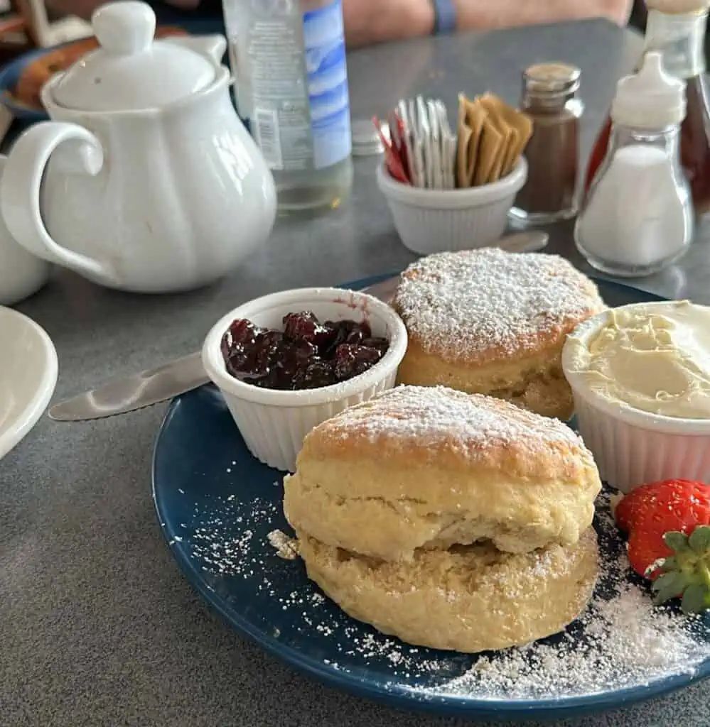 Photo of A Pot of Tea and two Huge Scones with Clotted Cream and Jam.