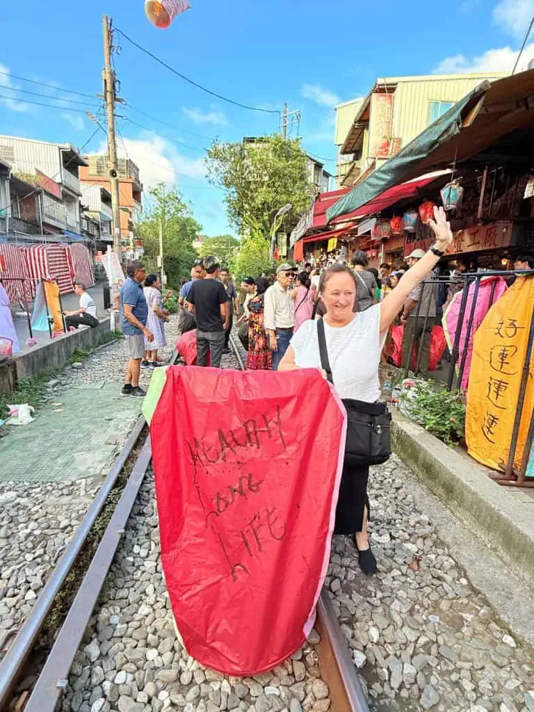 6 Day Taipei & Northern Taiwan Itinerary: Sun Moon Lake, Shifen & Taipei 101 35 The author launches one of her lanterns on the railroad tracks
