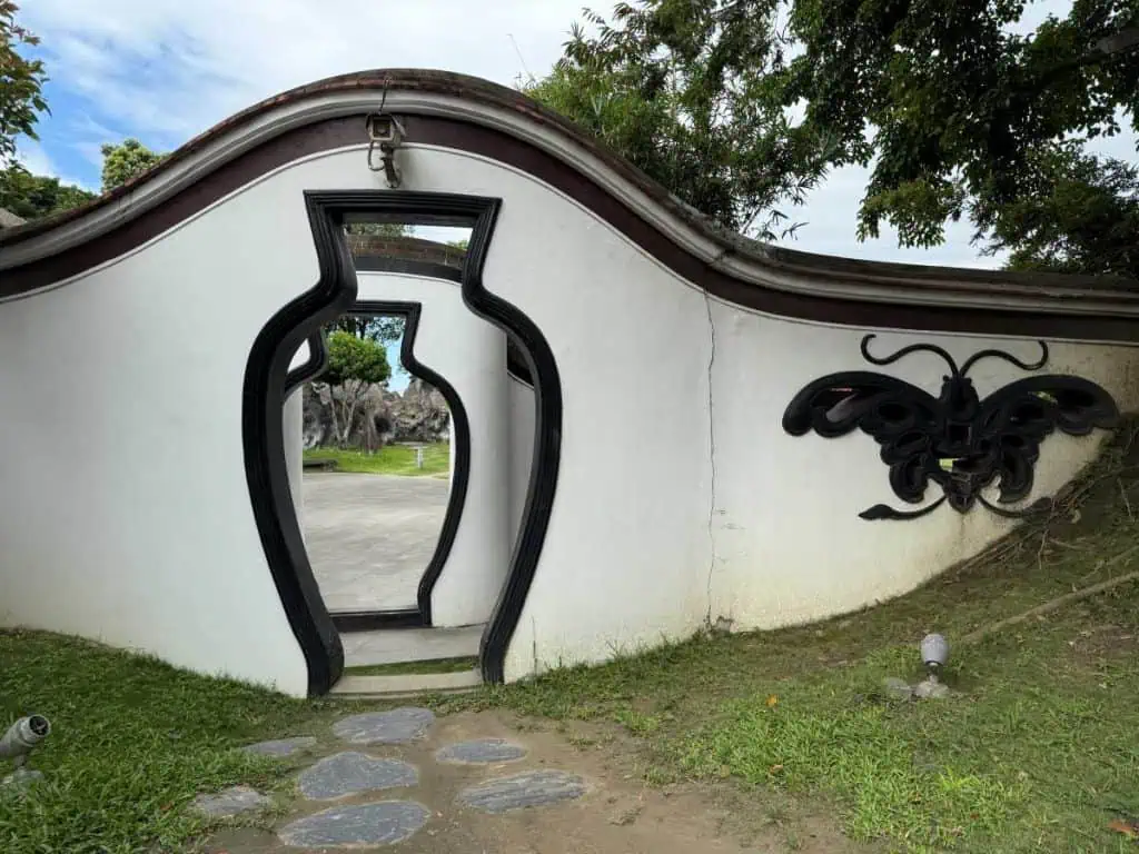 6 Day Taipei & Northern Taiwan Itinerary: Sun Moon Lake, Shifen & Taipei 101 8 Taipei Northern Taiwan Itinerary - The ornate entrance to the Lin Family Mansion and Garden with the door shaped as a flower vase and the symbolic butterfly to its right.