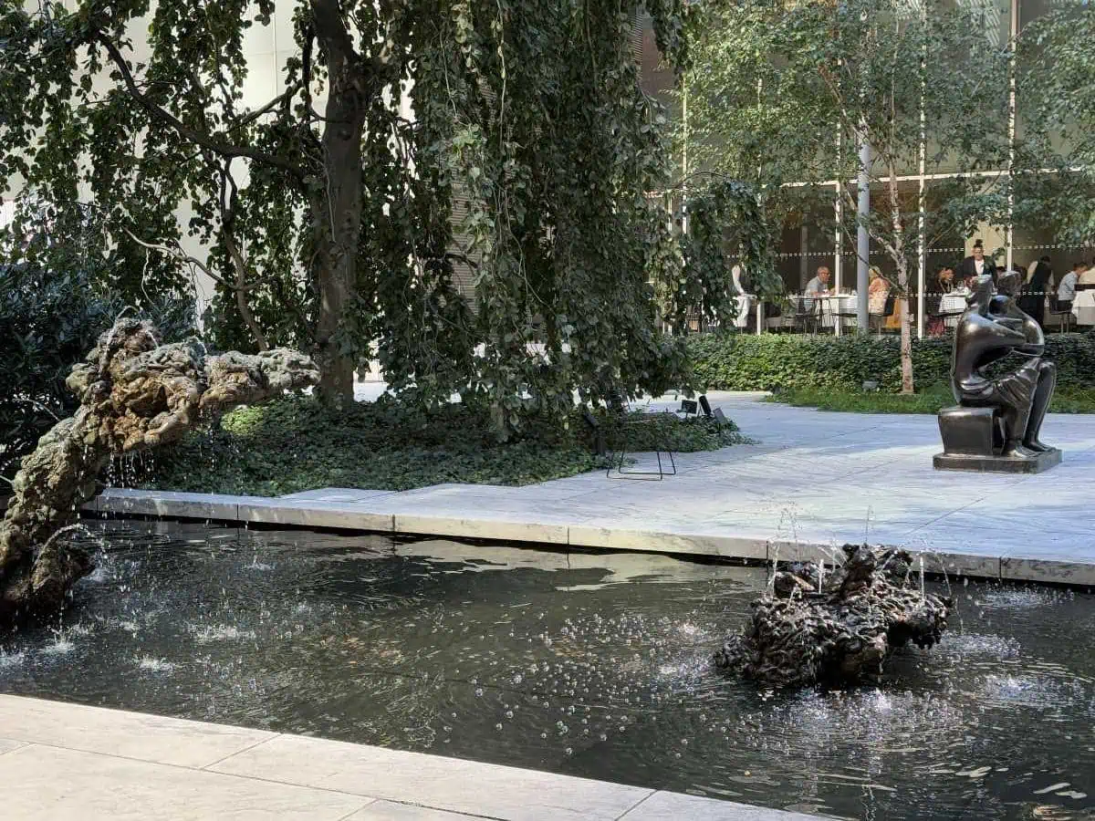 New York City Before A Cruise: Sailing From the Red Hook Cruise Terminal 4 MoMA NYC Park Fountain and park with water feature, trees, and seating area in an urban setting, perfect for relaxation and outdoor dining.