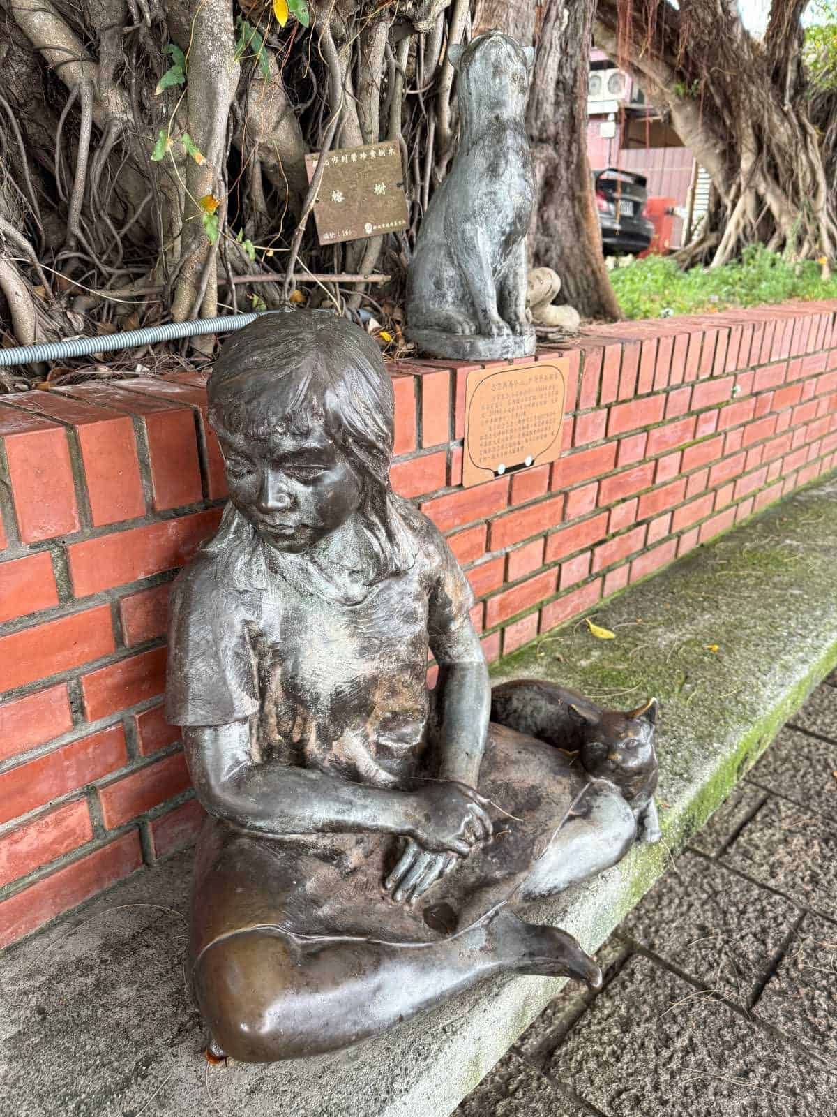 6 Day Taipei & Northern Taiwan Itinerary: Sun Moon Lake, Shifen & Taipei 101 42 Bronze statue of a girl sitting by the river with a cat by her side.