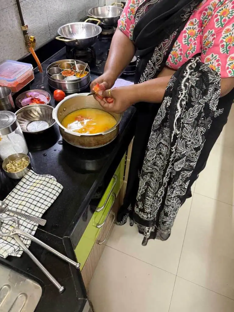 2 Days in Mumbai Before a Cruise: Markets, Street Life, Food, and Local Culture 25 Our Hostess prepares the soup adding vegetables to the dahl