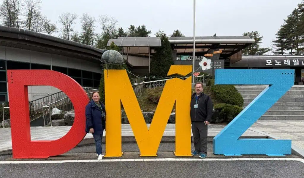 6 Days in Seoul: Royal Palaces, Korean BBQ, Hanbok, and the Unforgettable DMZ 1 6 Days in Seoul People standing next to large colorful DMZ sign at the Korean Demilitarized Zone, a popular tourist attraction and historical site in South Korea.
