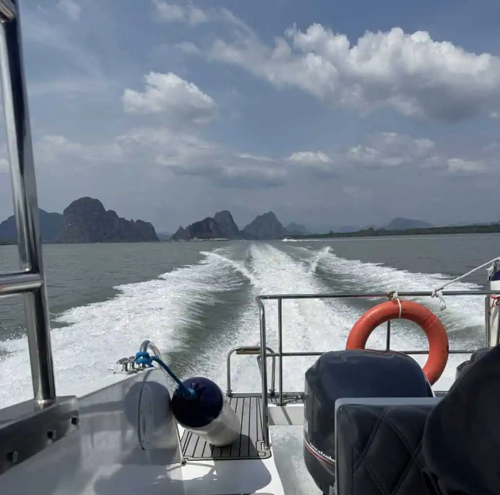 1 Day in Port: Phuket – A Private Phang Nga Bay Tour By Speedboat 1 Phuket – A Private Phang Nga Bay Tour By Speedboat View from a speedboat in Phang Nga Bay with limestone karsts and islands in the background, under partly cloudy skies.
