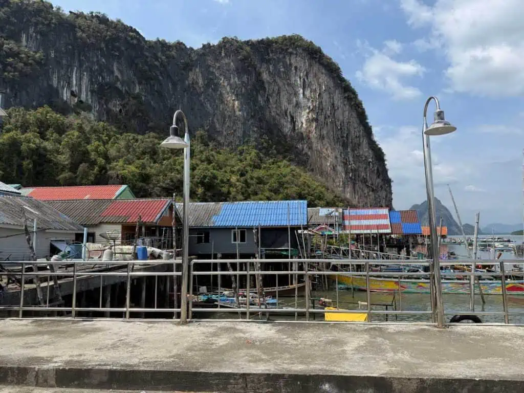 1 Day in Port: Phuket – A Private Phang Nga Bay Tour By Speedboat 13 Koh Panyee Scenic port in Phuket featuring stilt houses, boats, and limestone cliffs in the background, perfect for a private Phang Nga Bay tour by speedboat.